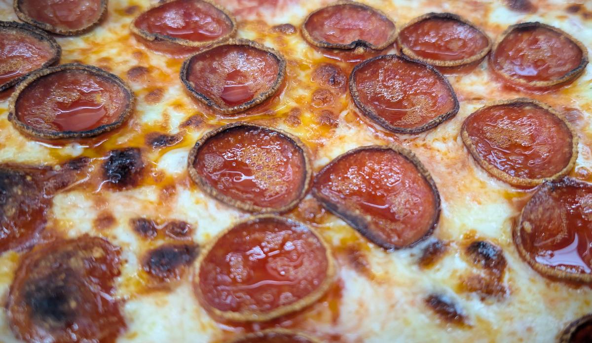Pepperoni cupped and crisping on a finished pizza