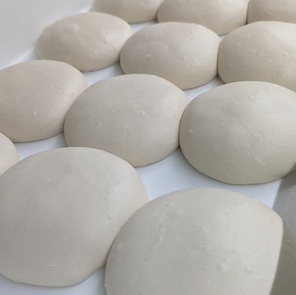 Dough balls proofing in the tray, ready to be stretched